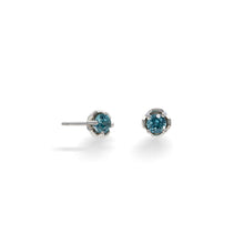 Load image into Gallery viewer, A pair of Zircon Hexpetal Studs against a white background. 4mm blue zircon gems nestled in a unique flower-inspired stud design with our trademark hexagonal accents, and featuring top quality natural blue zircon, these beautiful sterling silver earrings are a perfect way to show off your unique style.