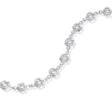 Load image into Gallery viewer, An image of the Starlight Prism Bracelet open and snaked over a white background. The sterling silver Starlight Prism Bracelet features a three dimensional hexagon design, glittering and reflecting light from many directions. With multiple links connecting with a lobster clasp, it's light, it's strong, and it's designed to be elegant enough for a fancy dress party, but strong enough for daily wear.