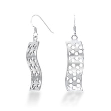 Load image into Gallery viewer, A pair of Hexwave Earrings hang in front of a white background. The sterling silver Hexwave earrings flow back and forth in a smooth wave design, cut with a hexagonal motif that breaks up the smooth lines, causing them to sparkle and shine at even the slightest motion. These hang down about 40mm each from Argentium hooks for tarnish resistance and added biocompatibility.