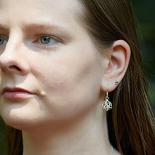 Load image into Gallery viewer, A young blonde model wears a pair of D20 Earrings outdoors in the sun. The image is a view looking toward her left ear as she looks off to the left of the frame. The D20 Earring hangs down, reflecting the sunlight.
