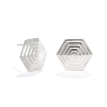 Load image into Gallery viewer, A photo of our Hexagonal Pyramid stud earrings against a white background. The earrings are 18mm wide at the widest point, and are made up of several layers of hexagons, rising as you move toward the center of the design.