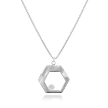 Load image into Gallery viewer, A sterling silver Hextech Necklace hangs in front of a white background. The futuristic, sterling silver HexTech Necklace features an array of hexagons at varying levels, hanging on a hexagonal bail from a 22" 1mm Italian made box chain. The recesses are depolished to give a variety of textures in the piece.