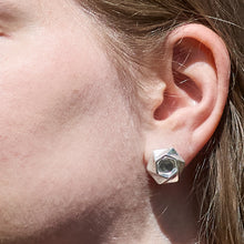 Load image into Gallery viewer, A closeup of the ear of a model wearing the Aperture Earrings
