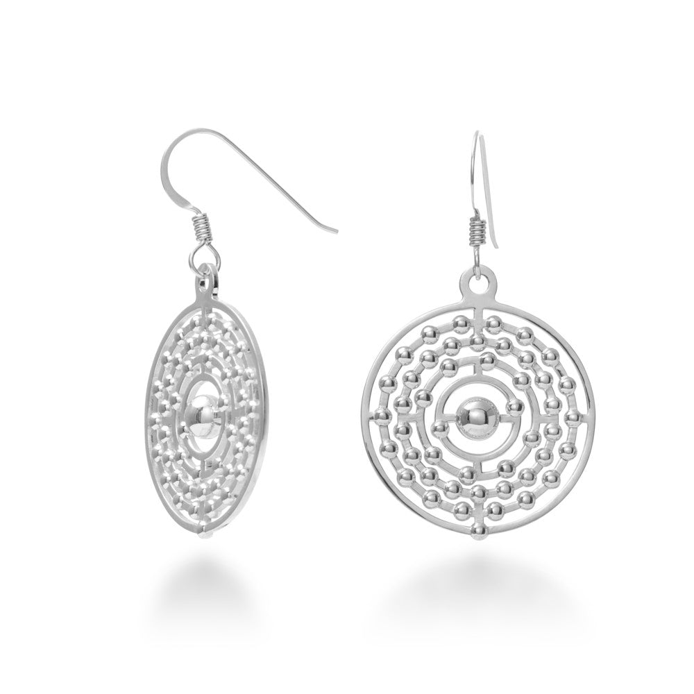 An image of the Atom Earrings over a white background. The sterling silver Atom Earrings are a wonderful way to show off your science-loving side. These lightweight dangle earrings are designed to look like a valence shell model of a silver atom. At 25.5mm wide and 30mm tall, and about 5mm thick at the thickest point, these earrings are stunners for an evening out, but comfortable enough for all-day wear. These come suspended from hypoallergenic Argentium silver hooks.