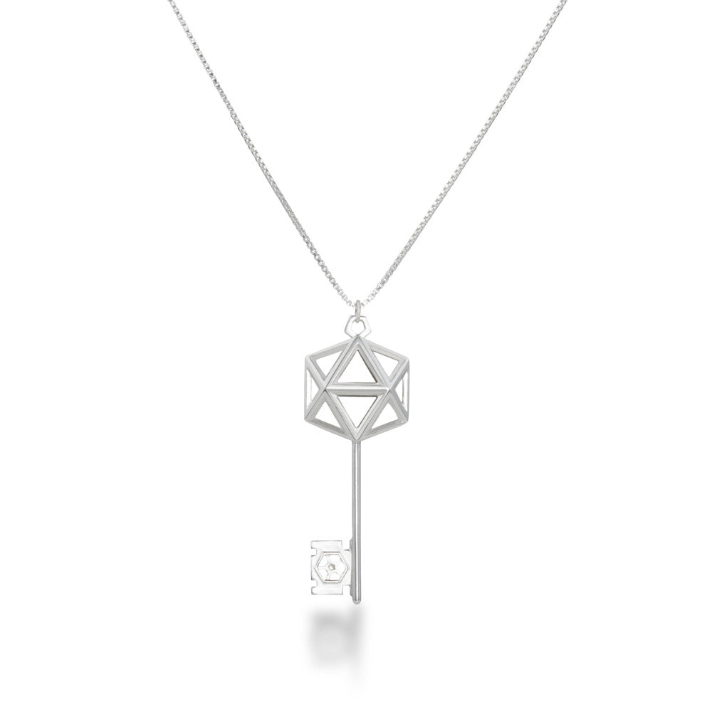 An image of the D20 Key Necklace over a white background The sterling silver D20 Key Necklace is a gaming-inspired design, matching well with our D20 earrings. The icosahedron at the top of the key is a flattened design for additional comfort, and the wards of the key feature a small D20 silhouette. This piece definitely makes the statement that you're ready for game night.