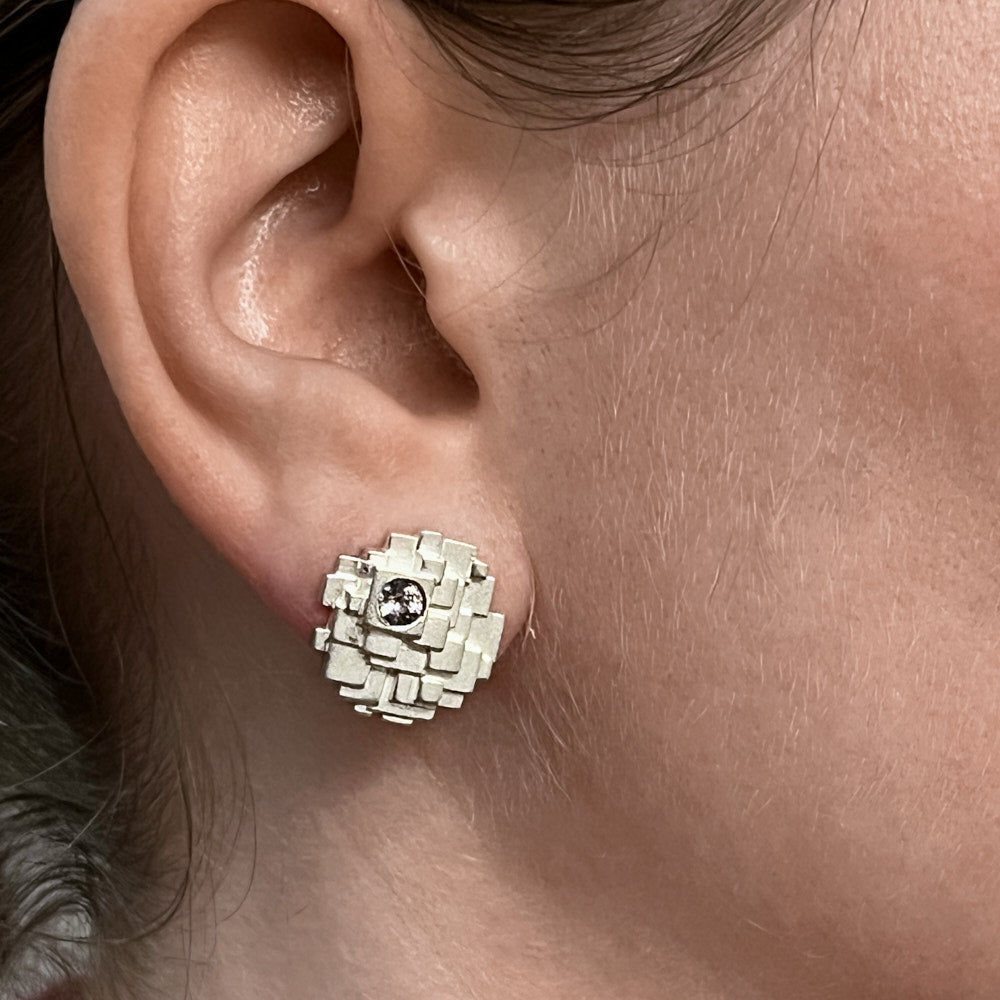 A closeup of a model's right ear wearing a Geode Earring