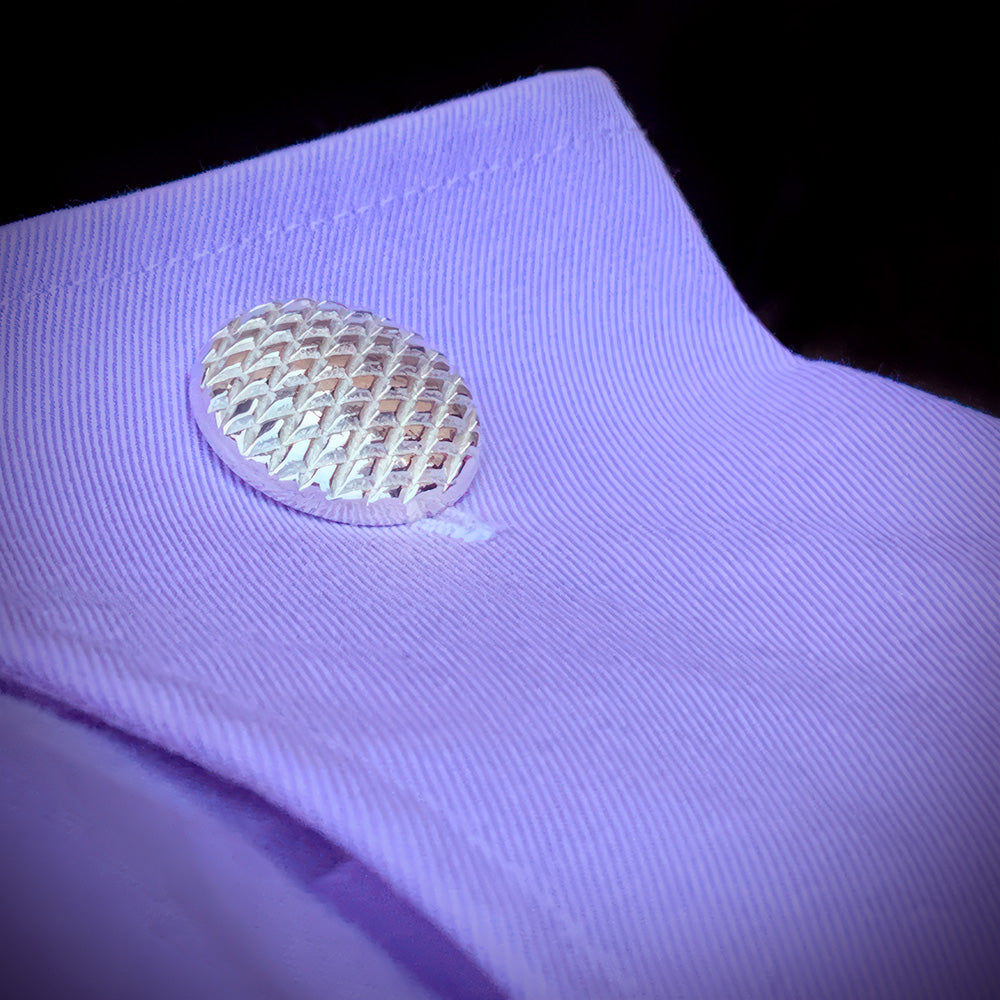A closeup photo of our Diamond Pattern Cufflinks on a purple shirt cuff.