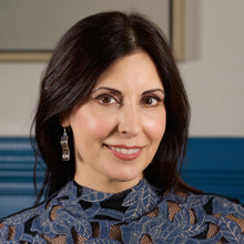 Load image into Gallery viewer, A smiling, brunette model is wearing a pair of Hexwave Earrings and looking at the camera. The model&#39;s head is turned a little toward her left and we&#39;re looking at the earring on her right ear. 
