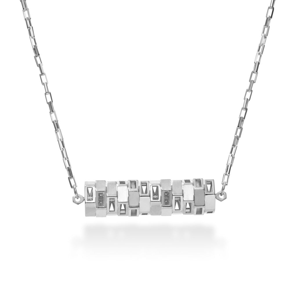 A photo of the Zeta Corridor hanging on its chain. A mix of elegance and mathematical precision, the sterling silver pendant is crafted from 12 hexagonal tubes, each rotated at a 30 degrees, creating a continuous pattern. Inside the tube are 12 individual hexagons suspended by 12 wires each through the center. A total of 144 spokes inside  create an incredible rigidity and complex form. The pendant sits inline in a diamond cut sterling chain. 