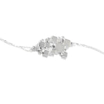 A product photo of our Sea of Squares Necklace at a 45 degree angle. The necklace pendant is an abstract collection of squares at varying heights, and the pendant sits inline along a rectangular link chain. 