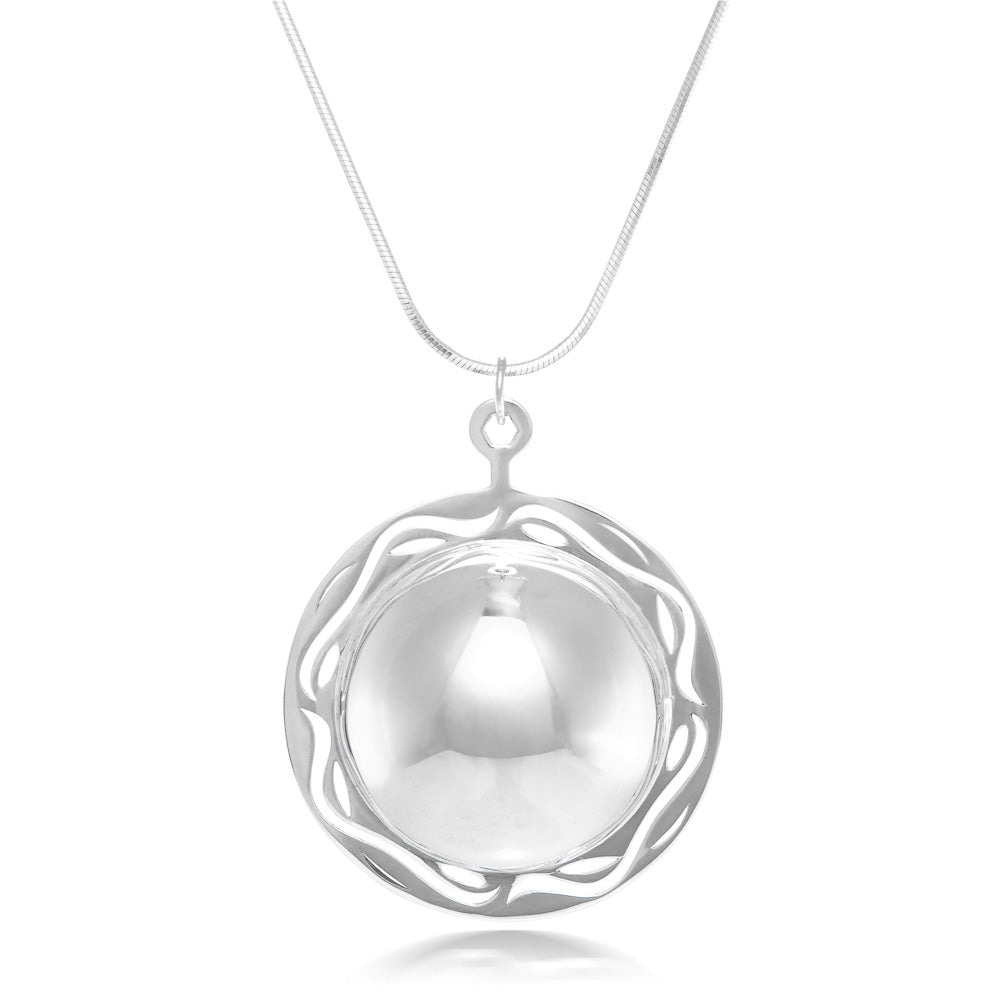 A product photo of our Scrying Pool Necklace, hanging in front of a white background. The necklace is a half dome of silver, shined to a mirror polish, and surrounded with a frame of silver sporting ripple designs. 