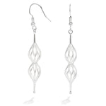 A photo of our Double Spiral Earrings against a white background. The earrings are a shape of twisted wire curves that taper to a rounded point at the bottom and a bail at the top. They hang from Argentium hooks. 
