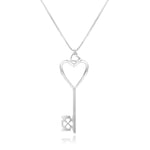 A Heart of Hearts Key Necklace hangs in front of a white background. The sterling silver key features an elegant heart shape with thickened edges, heart-shaped windows, and is topped with a heart-shaped bail. The wards are also hearts. 