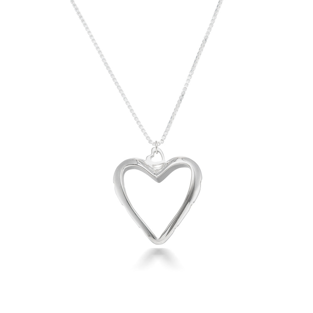 A production photo of our Heart of Hearts Necklace hanging in front of a white background. The Necklace is a large, heart shape, empty in the center, with a heart shaped bail and heart cutouts around the edge. 