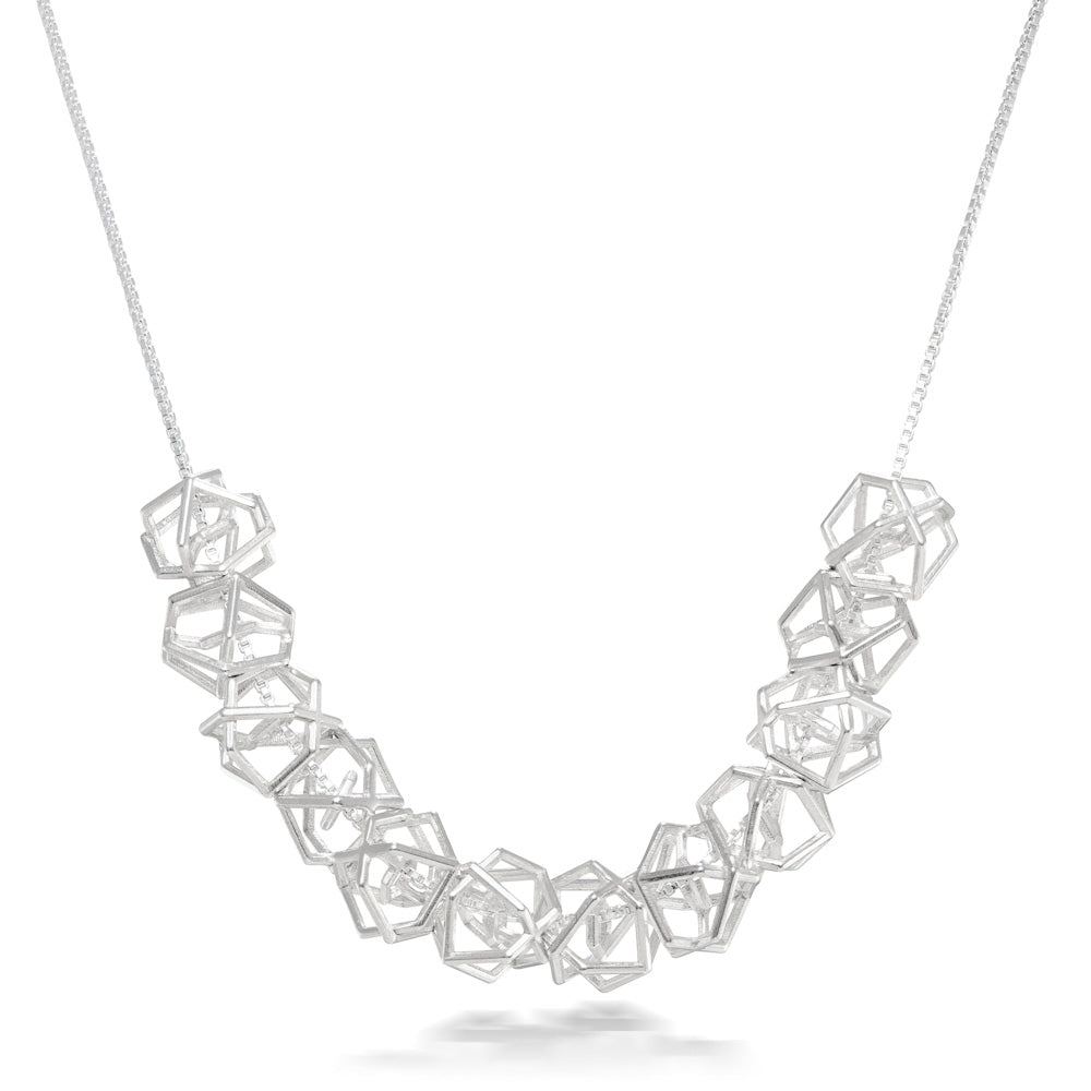 A product photo of our Hexagonal Ice Crystal Necklace hanging in front of a white background. The necklace consists of 12 three-dimensional hexagonal beads strung along a box chain.