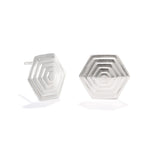 A photo of our Hexagonal Pyramid stud earrings against a white background. The earrings are 18mm wide at the widest point, and are made up of several layers of hexagons, rising as you move toward the center of the design. 