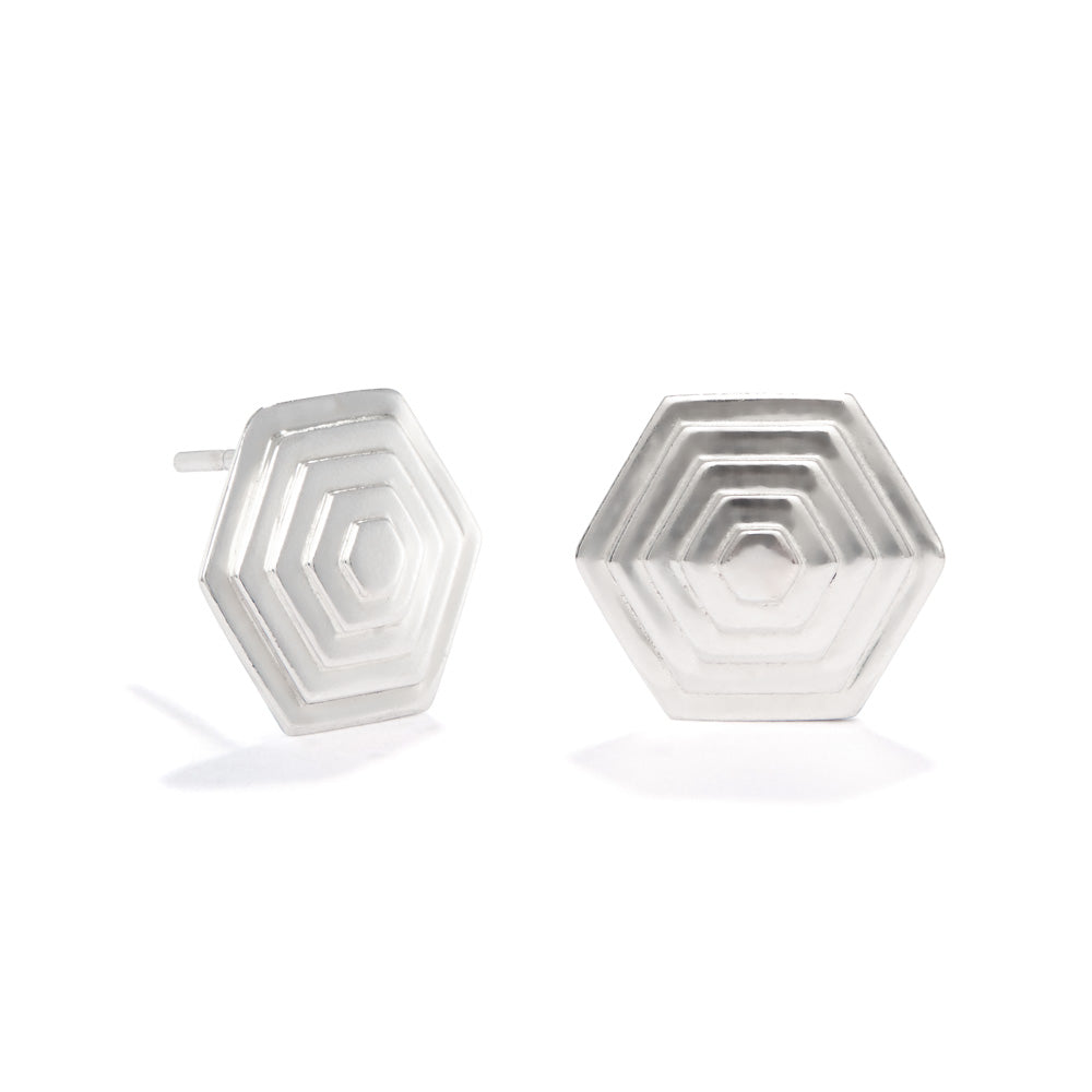 A photo of our Hexagonal Pyramid stud earrings against a white background. The earrings are 18mm wide at the widest point, and are made up of several layers of hexagons, rising as you move toward the center of the design. 