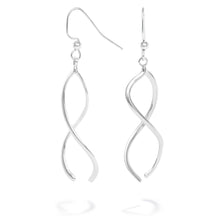 Load image into Gallery viewer, A photo of our Ribbon Earrings on a white background. The earrings are two curved ribbons of sterling silver that hang from a center point and wrap around each other as they dangle from a pair of Argentium silver hooks. 
