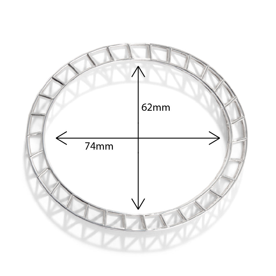 A product photo of our medium scaffold bangle, seen from a directly overhead. In the center of the bangle are measurements for minor and major diameters of the ellipse. 74mm on the major diameter and 62mm on the minor diameter