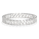 A product photo of our scaffold bangle, seen from a 45 degree angle above. The bangle itself is a scaffolding design, with two rows of supported structures joined together in an ellipse. 