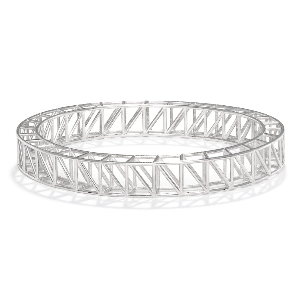 A product photo of our scaffold bangle, seen from a 45 degree angle above. The bangle itself is a scaffolding design, with two rows of supported structures joined together in an ellipse. 