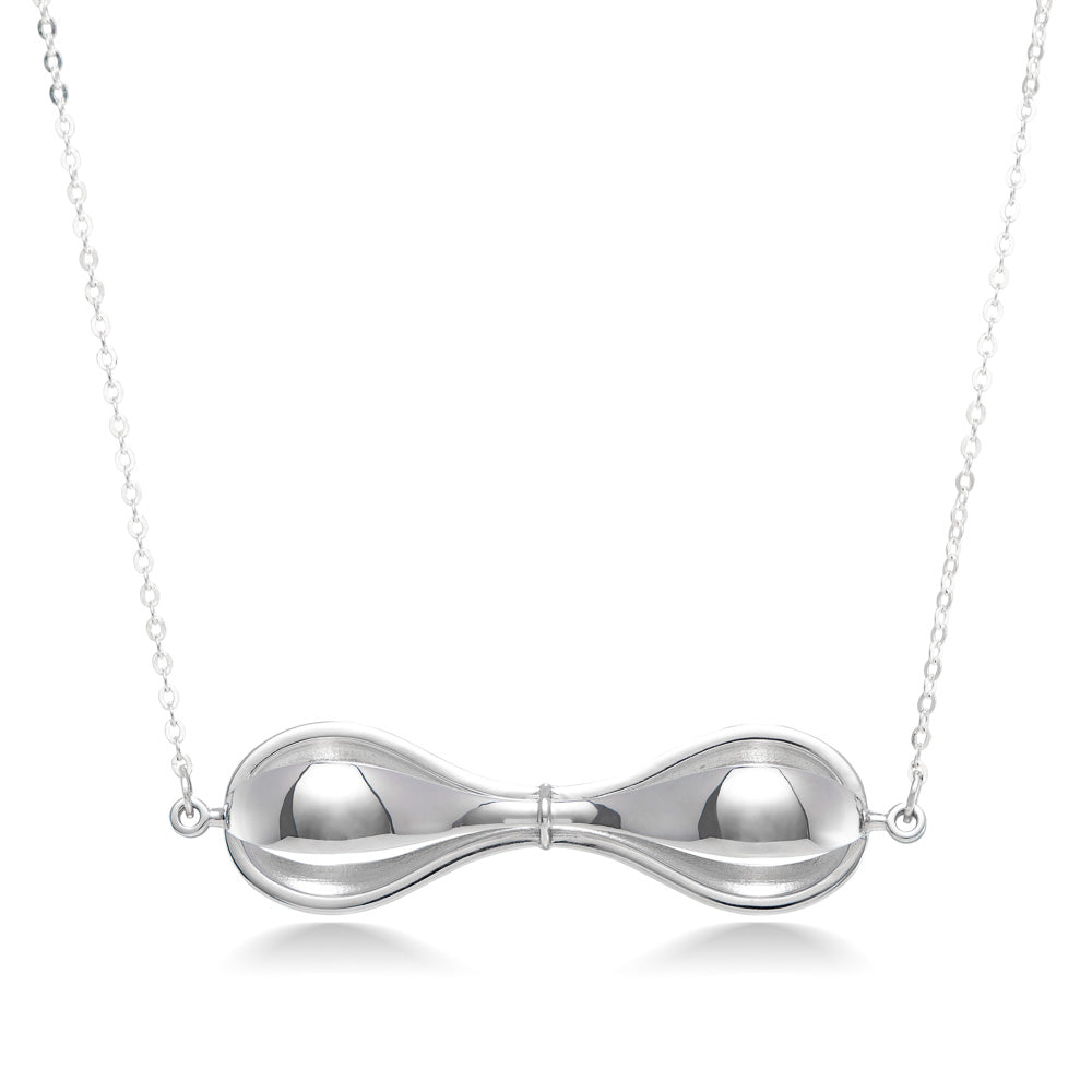 A photo of our sterling silver Tri-Curve Necklace hanging in front of a white background. The necklace is a combination of three thick silver curves, joined together at the ends and at the center. There are spaces matching the curve shape in between each curve. It hangs inline on a cable necklace. 
